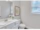 Bright bathroom featuring a white vanity with a single sink and neutral wall art at 6179 Ashbranch Dr, Acworth, GA 30101