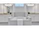 Bathroom with a soaking tub in front of the window and dual sink vanities at 6179 Ashbranch Dr, Acworth, GA 30101