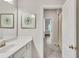 White bathroom vanity with an undermount sink, a gold framed mirror and an open door to the bedroom at 6179 Ashbranch Dr, Acworth, GA 30101