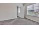 Carpeted bedroom with trim and neutral walls has a bright window and an open door to the closet at 6179 Ashbranch Dr, Acworth, GA 30101