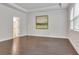 A bedroom is displayed with hardwood floors and natural light from the window with blinds at 6179 Ashbranch Dr, Acworth, GA 30101