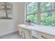 Close up of a bright desk area by a window overlooking green trees at 6179 Ashbranch Dr, Acworth, GA 30101