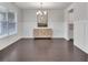 Dining room with modern lighting, stylish buffet, wainscoting, and gleaming dark wood floors at 6179 Ashbranch Dr, Acworth, GA 30101