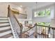 Open entryway with hardwood stairs, wrought iron railing, and great natural light flowing into the spacious home at 6179 Ashbranch Dr, Acworth, GA 30101