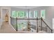 Second floor foyer with wrought iron railing overlooking the living room and large windows at 6179 Ashbranch Dr, Acworth, GA 30101