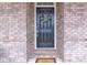 Classic front door with wreath set against a brick facade, providing a welcoming entrance at 6179 Ashbranch Dr, Acworth, GA 30101