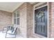 Inviting front porch with chairs, decorative wreath, and stylish brickwork create a warm welcome at 6179 Ashbranch Dr, Acworth, GA 30101