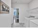 Well-lit laundry room with a washing machine and a wire rack over the appliances at 6179 Ashbranch Dr, Acworth, GA 30101