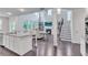 Open-concept living space with tall windows, a fireplace, and granite island, creating a modern airy feel at 6179 Ashbranch Dr, Acworth, GA 30101