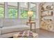 Living room boasts a chaise next to a table lamp and a large window at 6179 Ashbranch Dr, Acworth, GA 30101
