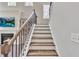 Staircase with wood treads and white risers with a metal railing at 6179 Ashbranch Dr, Acworth, GA 30101