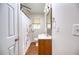 Cozy bathroom with wood style vinyl floors, single vanity and shower with curtain at 1693 Montreal Rd, Tucker, GA 30084
