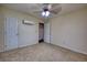 Bedroom with neutral carpet, ceiling fan, external AC unit and a large double closet at 1693 Montreal Rd, Tucker, GA 30084