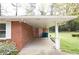 A brick home features a spacious carport with white pillars and a covered entrance for added protection and convenience at 1693 Montreal Rd, Tucker, GA 30084