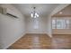Bright dining room with laminate floors, simple chandelier, and natural light at 1693 Montreal Rd, Tucker, GA 30084
