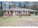 Inviting brick home featuring a classic design, covered carport, and neat front yard at 1693 Montreal Rd, Tucker, GA 30084
