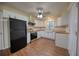 Modern kitchen with updated countertops, white cabinetry, stainless steel appliances, and new laminate flooring at 1693 Montreal Rd, Tucker, GA 30084