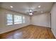 Spacious living room featuring new laminate wood floors and lots of natural light from large windows at 1693 Montreal Rd, Tucker, GA 30084