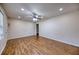 Updated living room showcasing laminate wood floors, fresh paint, and a ceiling fan at 1693 Montreal Rd, Tucker, GA 30084