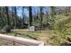 Landscaped backyard with a storage shed surrounded by mature trees at 1978 Fisher Trl, Atlanta, GA 30345