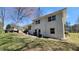 Backyard view of a two-story home with white painted brick, a deck, and a grassy yard at 1978 Fisher Trl, Atlanta, GA 30345