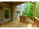Charming covered wood deck with scenic backyard views, perfect for outdoor relaxation at 2006 Towneship Trl, Roswell, GA 30075