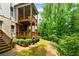 Backyard with a charming two-story wood deck overlooking a serene wooded area at 2006 Towneship Trl, Roswell, GA 30075