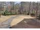 Spacious backyard with landscaped path and partial fence overlooking a peaceful pond at 2006 Towneship Trl, Roswell, GA 30075
