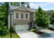 Charming townhome showcasing a brick facade, two-car garage, and manicured landscaping at 2006 Towneship Trl, Roswell, GA 30075