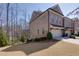 Beautiful brick townhome with a two-car garage and manicured lawn at 2006 Towneship Trl, Roswell, GA 30075