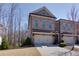 Charming brick townhome with a two-car garage and classic architectural details at 2006 Towneship Trl, Roswell, GA 30075