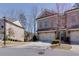 Attractive brick townhome featuring a two-car garage and landscaped front yard at 2006 Towneship Trl, Roswell, GA 30075