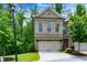 Charming brick townhome with a two-car garage and a manicured front yard at 2006 Towneship Trl, Roswell, GA 30075
