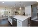 Bright and open kitchen with a large island, stainless steel appliances, and dark hardwood flooring at 2006 Towneship Trl, Roswell, GA 30075