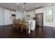 Spacious kitchen featuring a large island with seating, stainless steel appliances, and modern lighting fixtures at 2006 Towneship Trl, Roswell, GA 30075