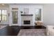 Living room with hardwood flooring, stone fireplace, large windows, and access to an outdoor space at 2006 Towneship Trl, Roswell, GA 30075