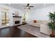 Bright living room featuring a decorative fireplace, dark hardwood floors and large windows at 2006 Towneship Trl, Roswell, GA 30075