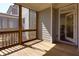Well-lit screened porch with wooden deck, adjacent to the home's exterior and accessible through a glass door at 2006 Towneship Trl, Roswell, GA 30075