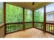 Serene screened porch featuring wooden floors, screens, and picturesque wooded scenery at 2006 Towneship Trl, Roswell, GA 30075