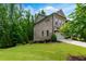 Spacious green side yard, complemented by lush landscaping and mature trees at 2006 Towneship Trl, Roswell, GA 30075