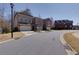 Street view of brick townhomes with manicured lawns and two car garages in a community at 2006 Towneship Trl, Roswell, GA 30075