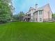 Spacious backyard featuring a large lawn, mature trees, a multilevel deck and a walkout basement at 414 Candler Trl, Canton, GA 30115