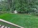 Lush backyard view from deck overlooking well-maintained lawn, fenced perimeter and charming garden shed at 414 Candler Trl, Canton, GA 30115