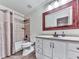 Bathroom featuring a tub-shower combo, white vanity, and a decorative framed mirror at 414 Candler Trl, Canton, GA 30115