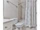 Cozy bathroom featuring a tub with a white shower curtain and a toilet at 414 Candler Trl, Canton, GA 30115