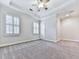 Bright bedroom featuring neutral paint and carpet, plantation shutters, and a ceiling fan at 414 Candler Trl, Canton, GA 30115