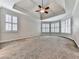 Large bedroom with trey ceiling, plush carpet, and windows with plantation shutters at 414 Candler Trl, Canton, GA 30115