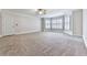 Large carpeted bedroom with bay windows, a ceiling fan, and white trim at 414 Candler Trl, Canton, GA 30115