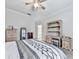 Bright bedroom with neutral carpet, a ceiling fan, and a view into an adjacent bathroom at 414 Candler Trl, Canton, GA 30115