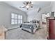 Charming bedroom with neutral carpet, a ceiling fan, and a view into the next room at 414 Candler Trl, Canton, GA 30115